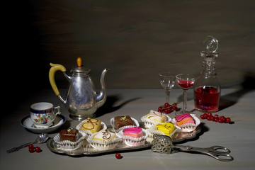 vintage style food still life with noble petit four candies and old dishes