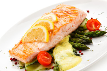 Grilled salmon with french fries on cutting board