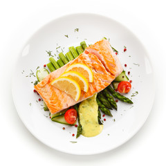 Grilled salmon with french fries on cutting board
