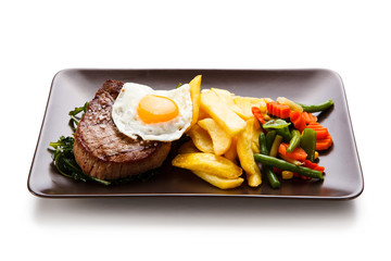 Grilled beefsteak with french fries and egg