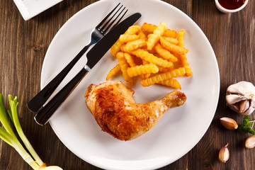 Roast chicken leg with french fries - restaurant