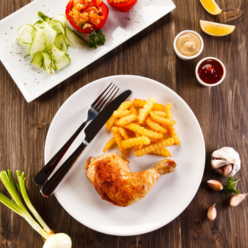 Roast chicken leg with french fries - restaurant