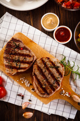 Grilled beefsteaks on cutting board - dinner preparation