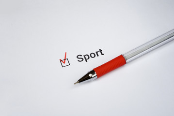 questionnaire. Red pen and the unscription Sport on white paper