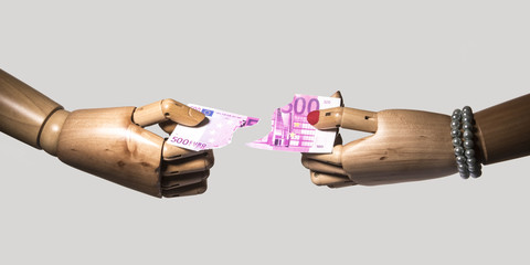 Couple rips on a banknote of 500. Concept of divorce and a couple sharing. Isolated on grey...