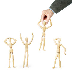 Man grabs another person by the head. Abstract image with wooden puppets