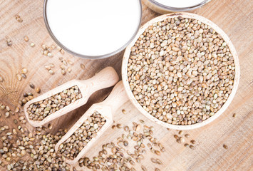 Hemp milk, seeds on wooden background . Close Up .