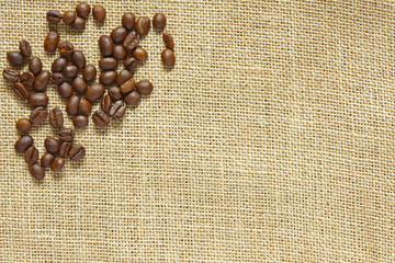 coffee bean on sackcloth or gunny and top view with copy space for cafe or coffee shop drink background