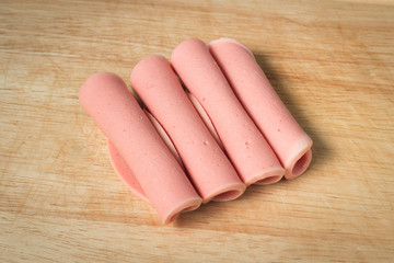 rolled ham arrange on wood block