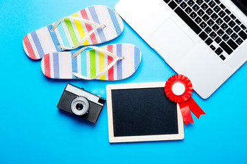 blackboard, sandals, camera, laptop and prize ribbon