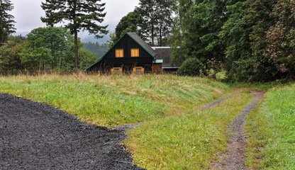 Small hut with yellow colour windows