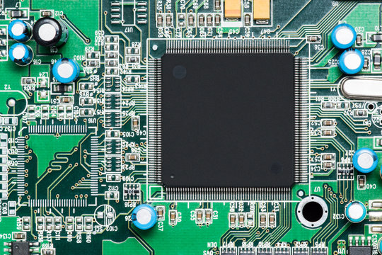 top view of microprocessor and other component on green electronic circuit board