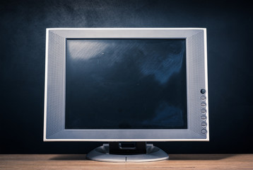 still life photography : old computer monitor on wood table with art dark background