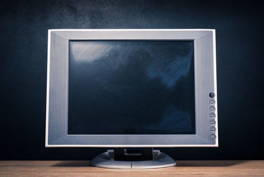 still life photography : old computer monitor on wood table with art dark background