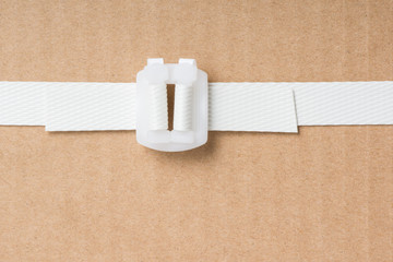 close up of freight parcel with plastic fasten strap background
