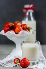 Fresh cow milk and ripe organic strawberry