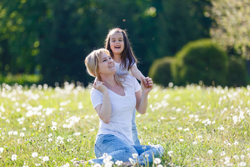 Mother and daughter in field with colorful flowers