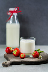 Fresh cow milk and ripe organic strawberry