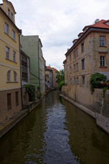 Fototapeta na wymiar Small canal between the buildings