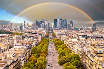 Rainbow over the La Defense Financial District, Paris, France in spring. Traffic on Champs-Elysees...