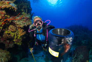 A female hunter is on the reefs trying to remove as many invasive lionfish as possible to help the...