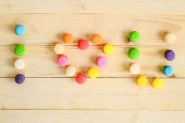 Colorful macaroon on wood background.