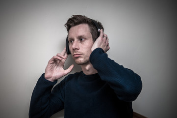 man listening to music on wireless headphones