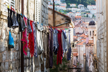 Fototapeta na wymiar Laundry drying above a narrow street