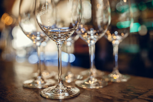 Close up picture of empty glasses on the wooden counter  in restaurant