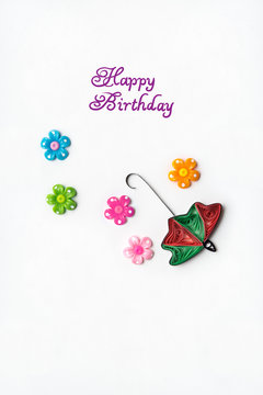 Happy birthday / Creative concept photo of an umbrella with flowers made of paper on white background.