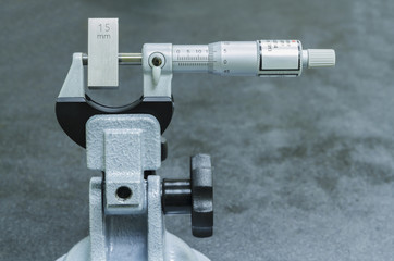 Calibration outside micro meter with gauge block in  laboratory.