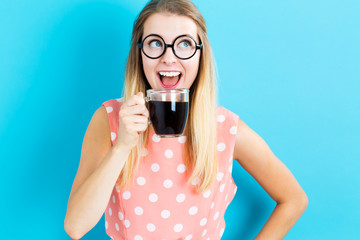 Happy young woman drinking coffee