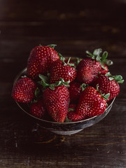 Ripe organic strawberry on a wooden background in a rustic style