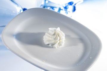Fototapeta na wymiar whipping cream on white plate 