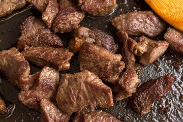 Fried beef goulash in a frying pan. Nutritious, tasty and low-fat dish.