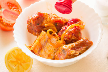Raw pork ribs in marinade and ingredients. The concept of cooking.