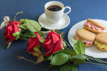 Cakes and roses on denim. Romantic composition. Holiday card.
