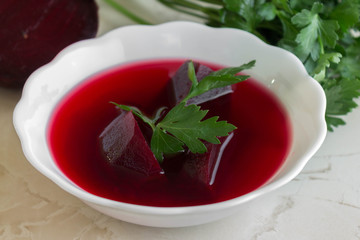 Beet soup in a white bowl. Delicious dietary dish.