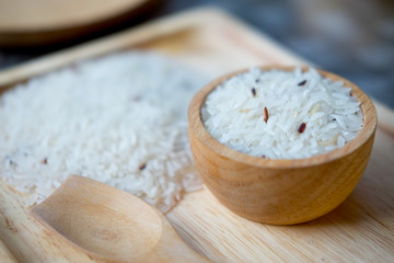 Thai Jasmine rice in wooden bowl, selective focus