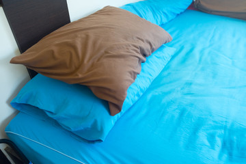 pillows setting on bed with blue color bedding style