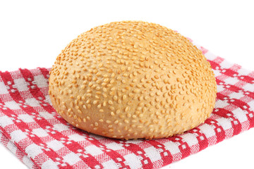 Round sandwich bun with sesame seeds isolated on white background