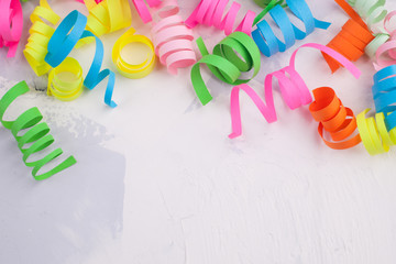 Festive party or carnival border of corful confetti on a light background with copy space