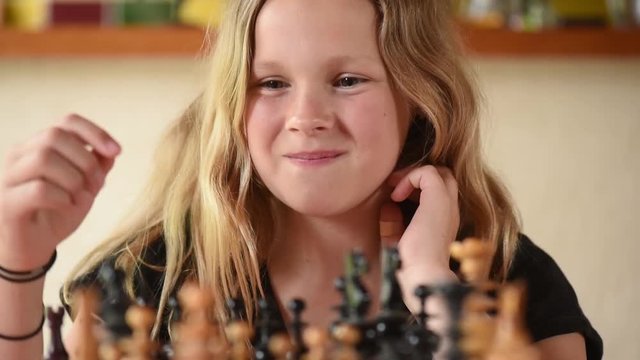 Reflective teenager in front of a chess game