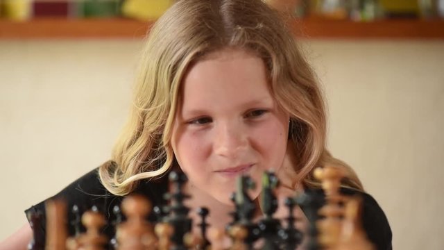 Reflective teenager in front of a chess game