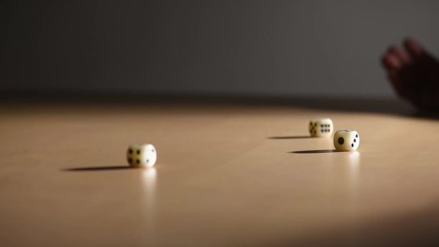 One hand dice on a table