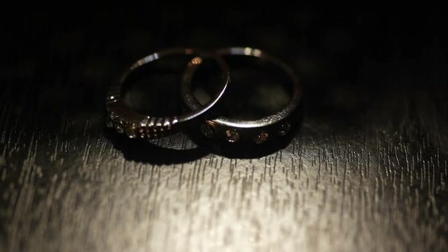 Two wedding gold rings and stars silhouettes