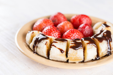 Fresh strawberries with sliced banana and topped chocolate cream