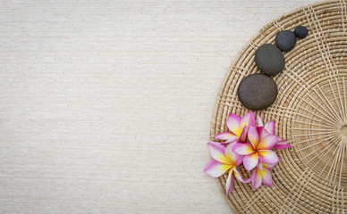 Spa concept background, Plumeria flower and round stone on rattan try 