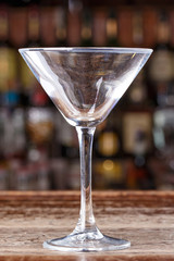 Empty cocktail glass on the background of the bar