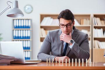 Businessman with dominoes in the office
